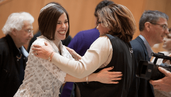 Rabbi Saphire and congregant greet each other warmly