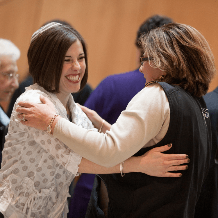 Rabbi Saphire and congregant greet each other warmly