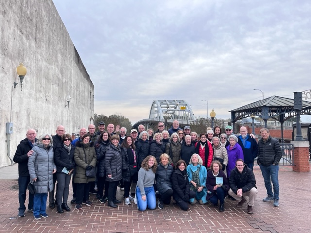 TBE travelers on the Civil Rights Journey stand in front of the Edmund Pettus Bridge